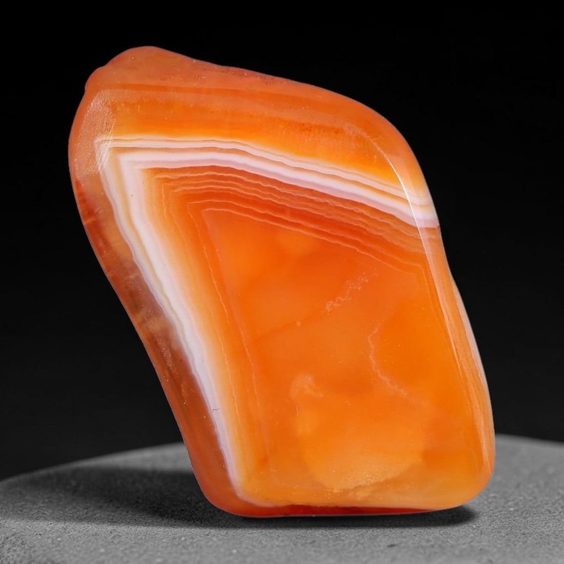 44ct Natural Brazilian Carnelian Banded Agate Sliced Rough Slab, 89YK: This polished slice specimen is natural carnelian banded agate sourced from Brazilian deposits, featuring concentric layered banding of rich orange, peach, and deep crimson-red chalcedony. One flat fa