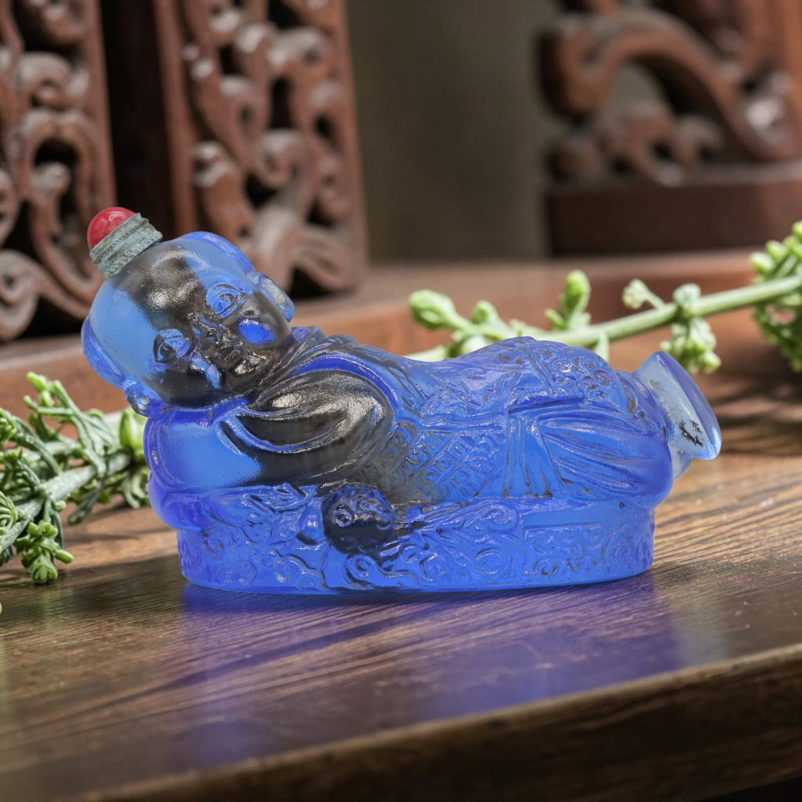 Vintage Chinese Blue Liuli Glass Snuff Bottle - Reclining Child Figurine, 58YF: Crafted from translucent cobalt blue liuli glass, this vintage Chinese snuff bottle is modelled as a reclining child figure. The glass exhibits a rich, saturated blue hue with subtle tonal variations 