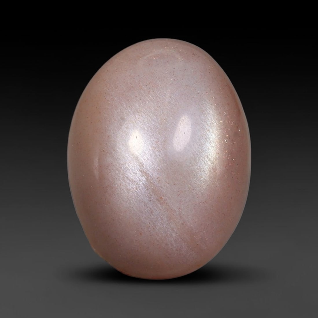 7.74 Carats Natural Ceylon Peach Moonstone Loose Gemstone, 47WJ: This natural Ceylon moonstone carries dimension measurements of 15.2x11.5x6.1mm, a premium feldspar mineral sourced from Ceylon's historic moonstone mining grounds celebrated for stones displaying cha