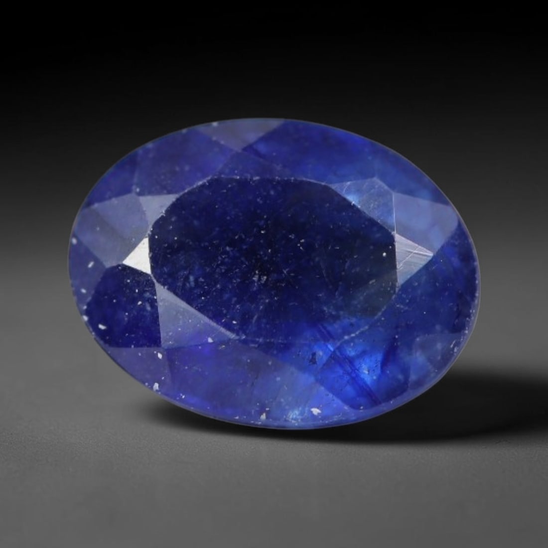 1.72 Carats Royal Blue Sapphire Oval Faceted Loose Gemstone, 38WS: This classic oval faceted sapphire displays rich saturated royal blue color glowing through crisp polished multi-facet cuts, featuring natural fine internal fissures and tiny scattered mineral micro s
