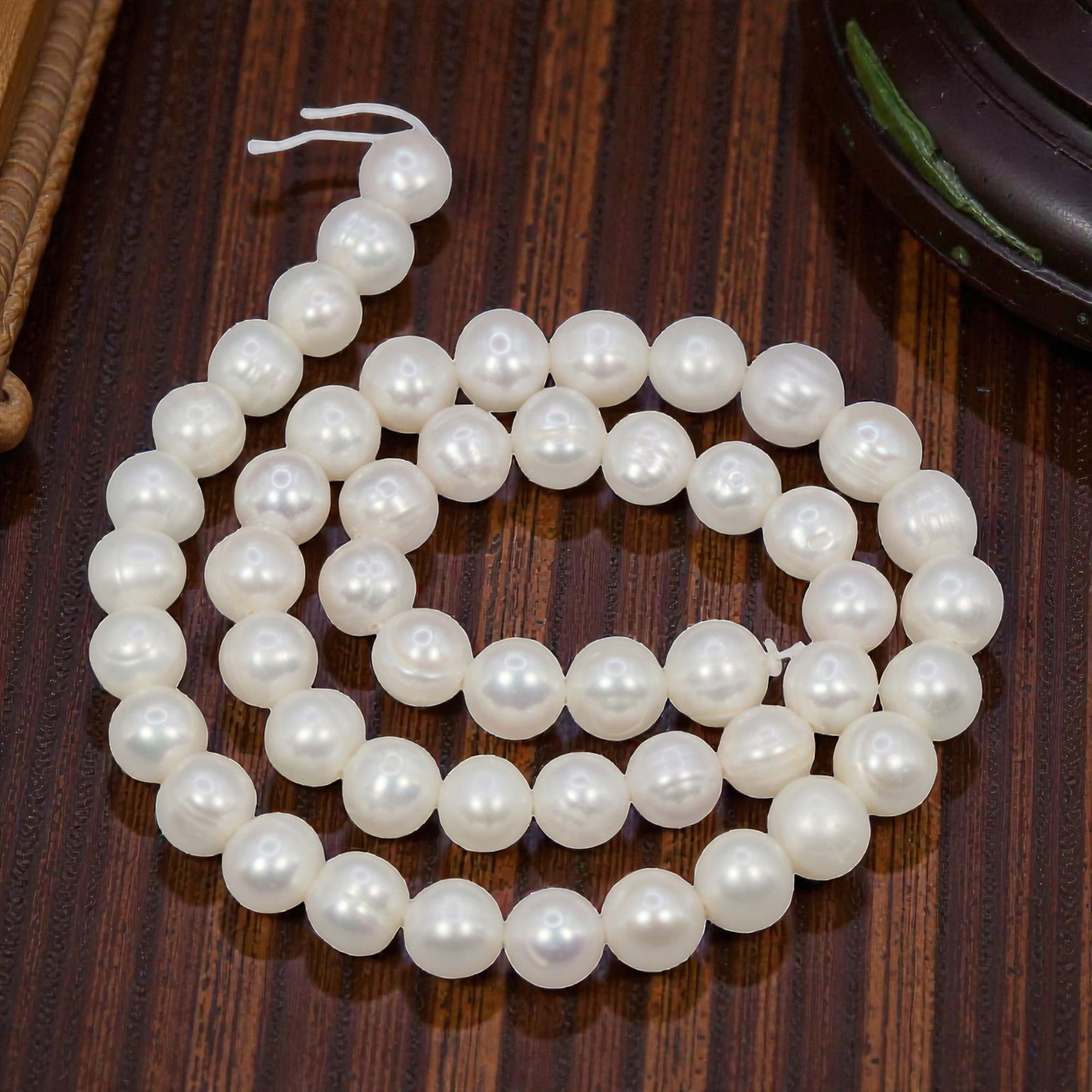 A Strand of Cultured Pearls, 20th Century, 84ZJ: Composed of uniformly sized, near-round cultured pearls with a creamy white body color and subtle iridescent overtones, the strand is strung in a single continuous line. Each pearl exhibits a smooth, 