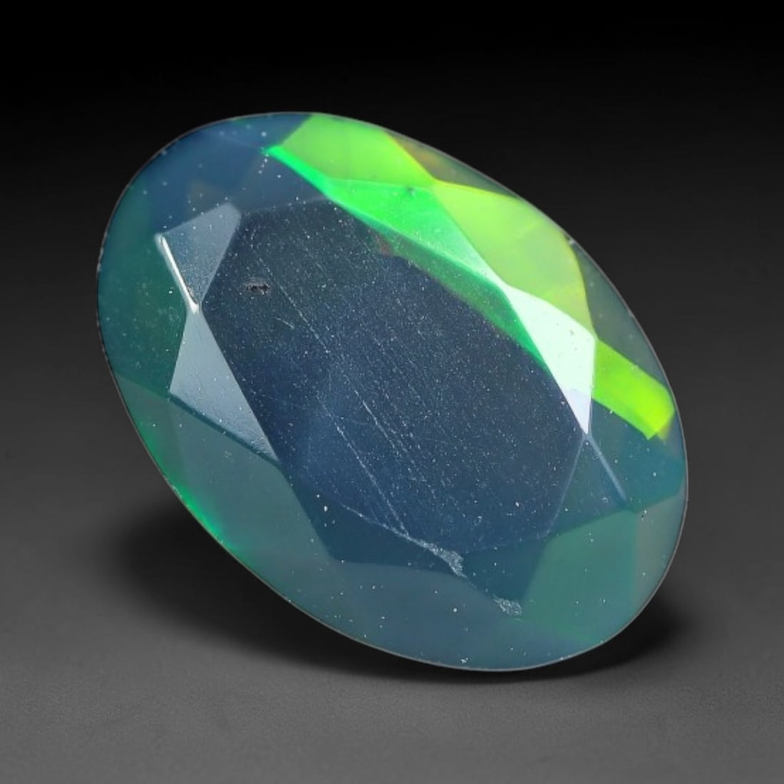 1.43 Carats Natural Ethiopian Welo Black Opal Oval Faceted Loose Gemstone, 86XX: This opal is mined from the Welo region of Ethiopia and expertly faceted and polished into an oval shape by professional lapidary techniques. Natural fine internal particles and faint natural fissures