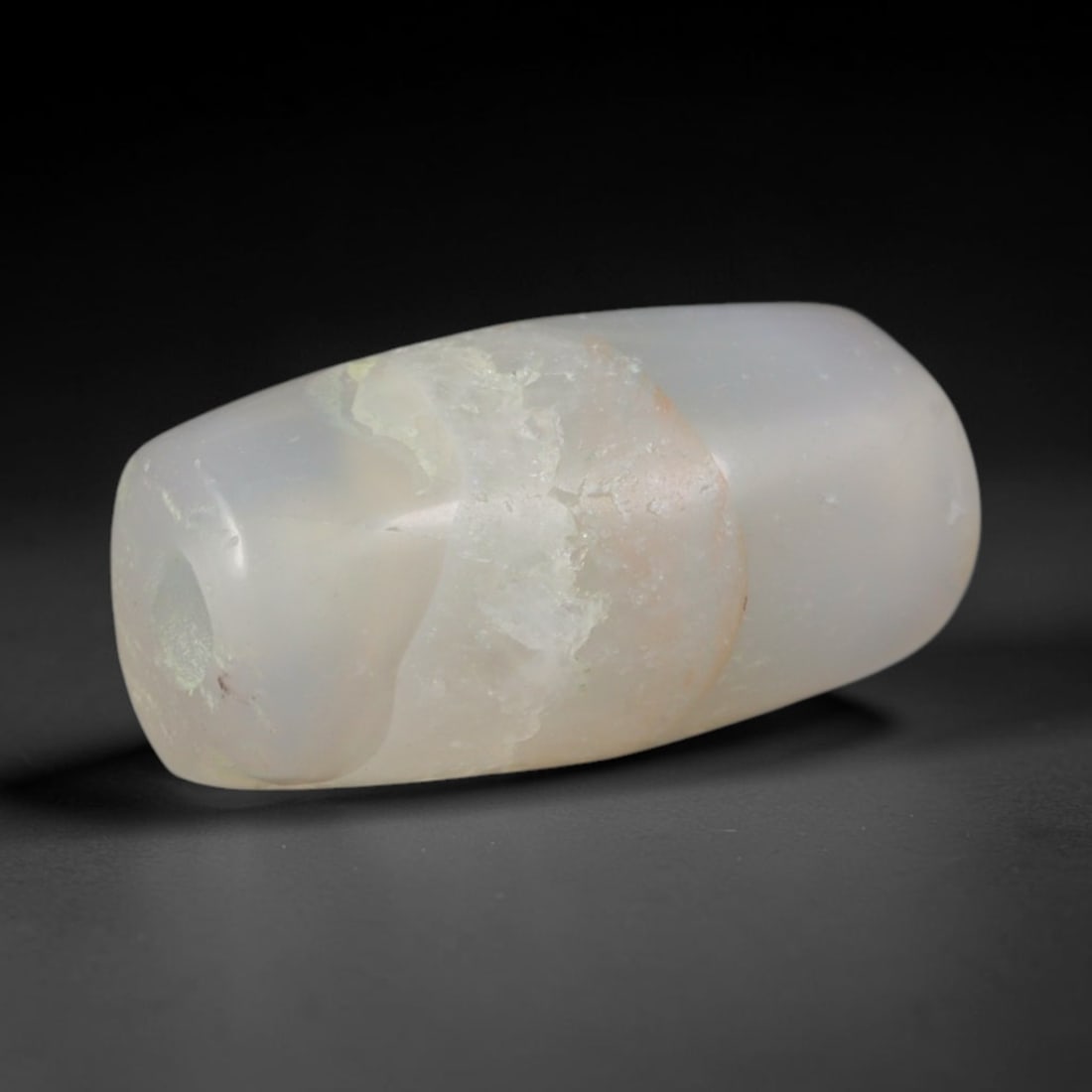 Ancient Central Asian Steppe Frosted Pale Chalcedony Barrel Trade Bead (800-200 BCE), 38XD: This tapered barrel-shaped translucent chalcedony bead originates from nomadic steppe artisan workshops, crafted as subtle lightweight protective talismans traded across early Eurasian caravan routes.