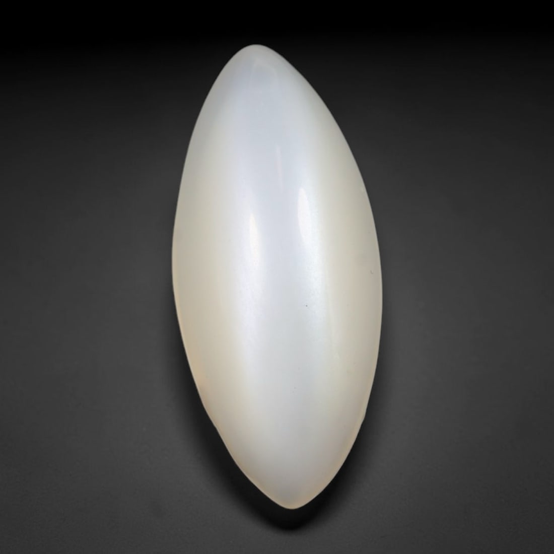 6.43 Carats Natural Ceylon Soft Milky White Moonstone Marquise Cabochon Loose Gemstone, 76WS: This milky white marquise moonstone displays a uniform soft creamy pale body with faint diffused adularescent sheen visible across its smoothly polished convex surface, sourced from classic Ceylon gem