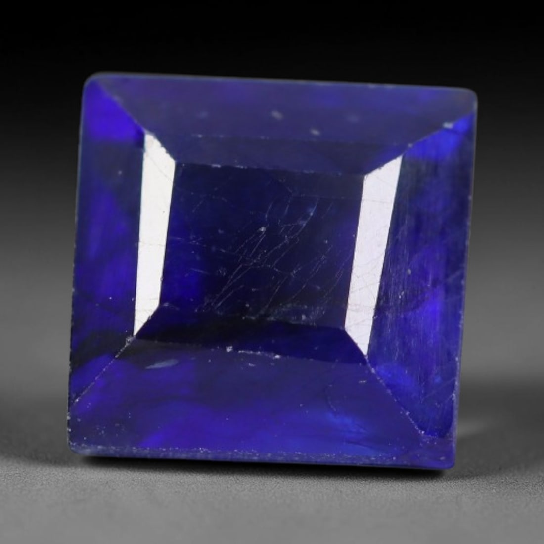 3.16 Carats Royal Blue Sapphire Square Emerald Cut Loose Gemstone, 36WS: This neat square emerald cut sapphire showcases deep, saturated royal blue color, enhanced by clean reflective step facets. Natural internal fine fissures and scattered tiny mineral specks can be obse