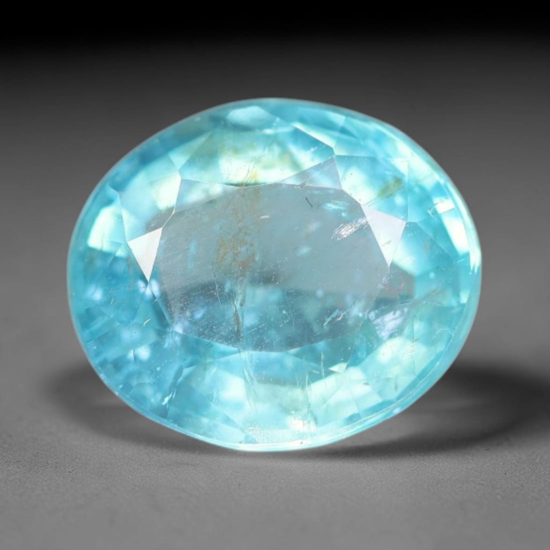 1.61 Carats Natural Bright Cyan Blue Apatite Oval Faceted Loose Gemstone, 20WW: This apatite is sourced from natural mineral deposits and processed with precise faceting and uniform high-gloss polishing by professional lapidary craftsmanship. Natural fibrous textures and tiny sca