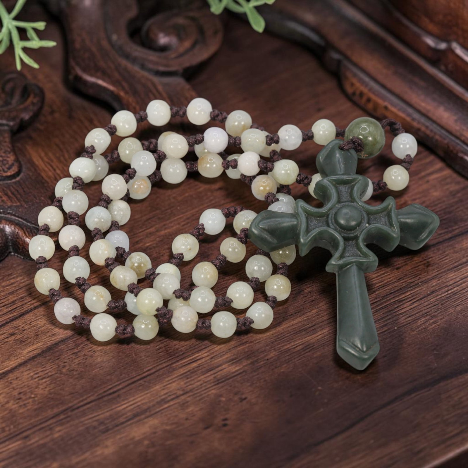 Burmese Jadeite Beaded Necklace with Natural Chinese Jade Cross Pendant, 62YJ: This necklace features a hand-carved natural Chinese jade cross pendant paired with natural Burmese jadeite round beads, strung on a brown cord. The pendant is crafted from deep, rich green jade, depi
