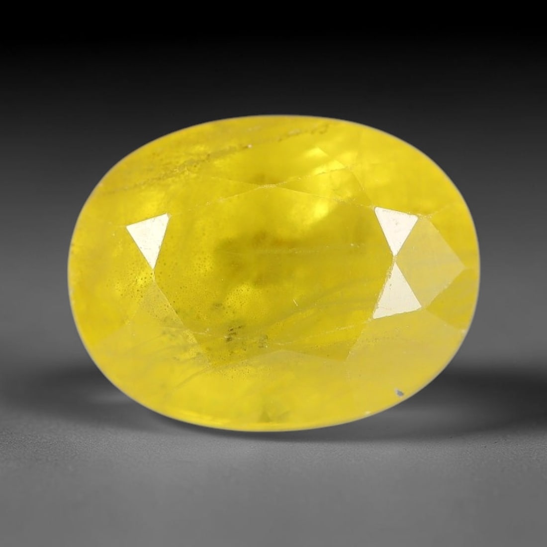 3.51 Carats Natural Yellow Sapphire Oval Faceted Loose Gemstone, 52XM: This natural yellow sapphire features a classic oval brilliant faceted cut, holding consistent warm golden-yellow color throughout the corundum crystal. Fine microscopic mineral specks and faint natur