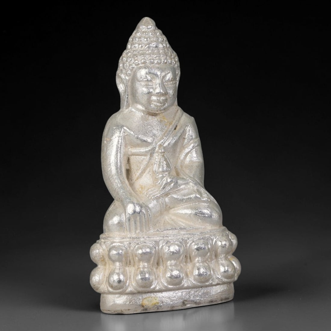 Thai Silver Tone Metal Mini Sacred Statuette Amulet, 88ZB: Small cast metal sacred figurine with fine sculpted detailing on the cranial structure, robe folds and embossed layered base. Subtle discoloration and light handling wear can be seen on the surface fr