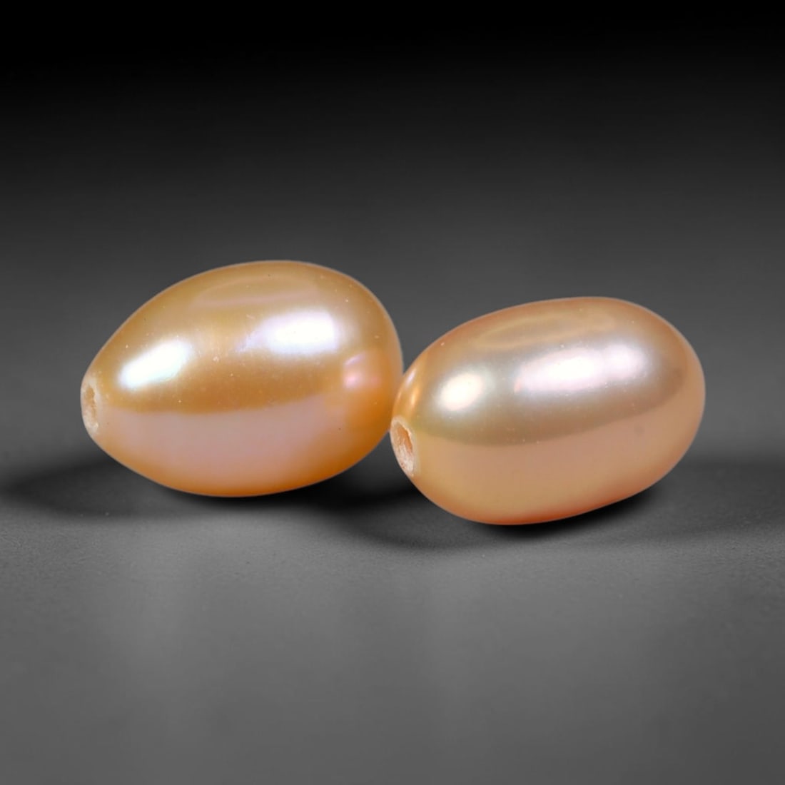 3.68ct Natural Peach Golden Orient Freshwater Egg Shape Pearl Pair, 62XZ: Matched pair of natural freshwater egg/oval pearls, uniform 8.2x5.7mm with clean through-drilled holes ready for jewelry setting. Each pearl features smooth silky nacre with a soft warm peach-gold bas