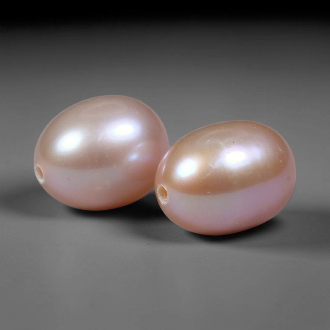 6.26ct Natural Soft Mauve Pink Orient Freshwater Egg Shape Pearl Pair, 66XZ: Matching pair of natural freshwater egg/oval pearls, uniform dimensions 9.2x6.8mm with neat fully drilled through holes ready for immediate jewelry assembly. Each pearl boasts a smooth satiny nacre su