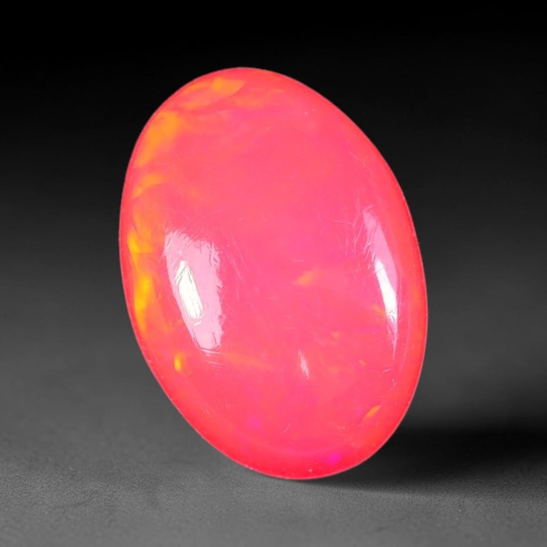 1.91ct Natural Ethiopian Welo Pink Fire Opal Oval Cabochon Loose Gemstone, 58XX: This opal originates from Ethiopian Welo opal bearing strata and is crafted into a sleek oval cabochon with smooth, high-gloss polishing through professional lapidary work. Soft pink base tone paired 