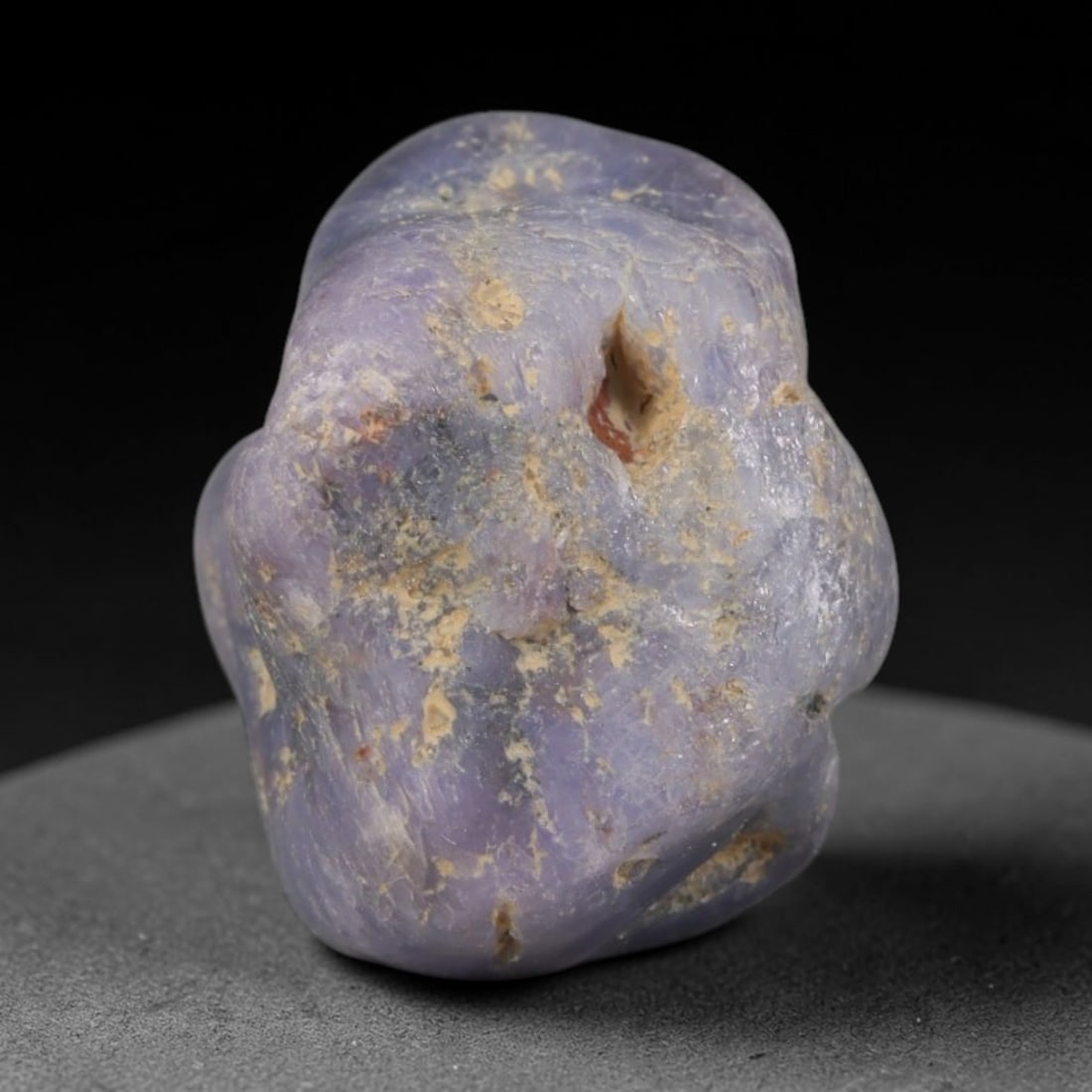 33ct Natural Unheated Sri Lankan Purplish Blue Sapphire Rough, 44YQ: This natural corundum rough is an unheated purplish blue sapphire sourced from Sri Lankan alluvial gem deposits, featuring an irregular natural native form with residual pale yellow-brown mineral matr