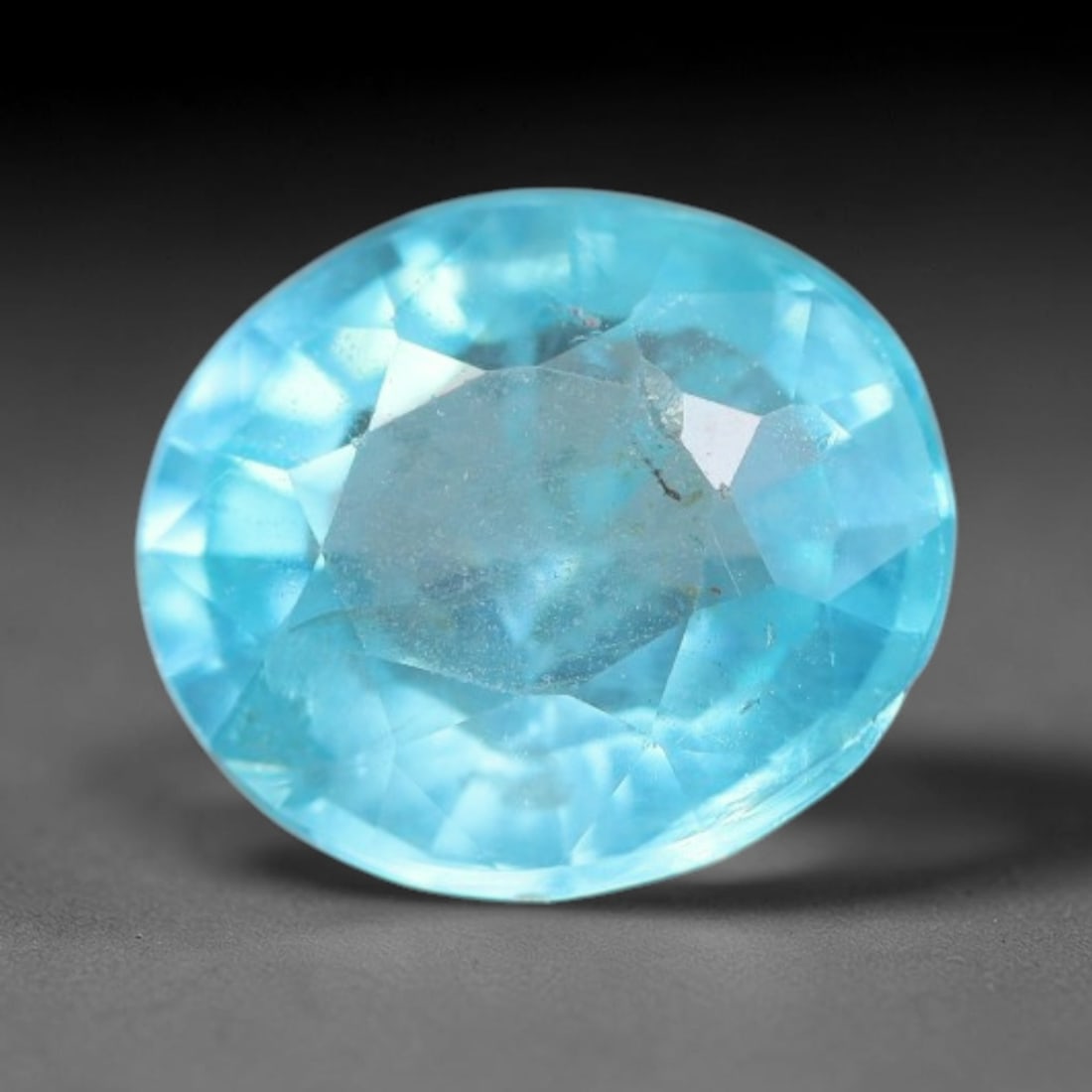 1.08 Carats Natural Bright Cyan Blue Apatite Oval Faceted Loose Gemstone, 13WW: This apatite is sourced from natural mineral deposits and processed with precise faceting and uniform high-gloss polishing by professional lapidary craftsmanship. Natural fibrous textures and tiny sca