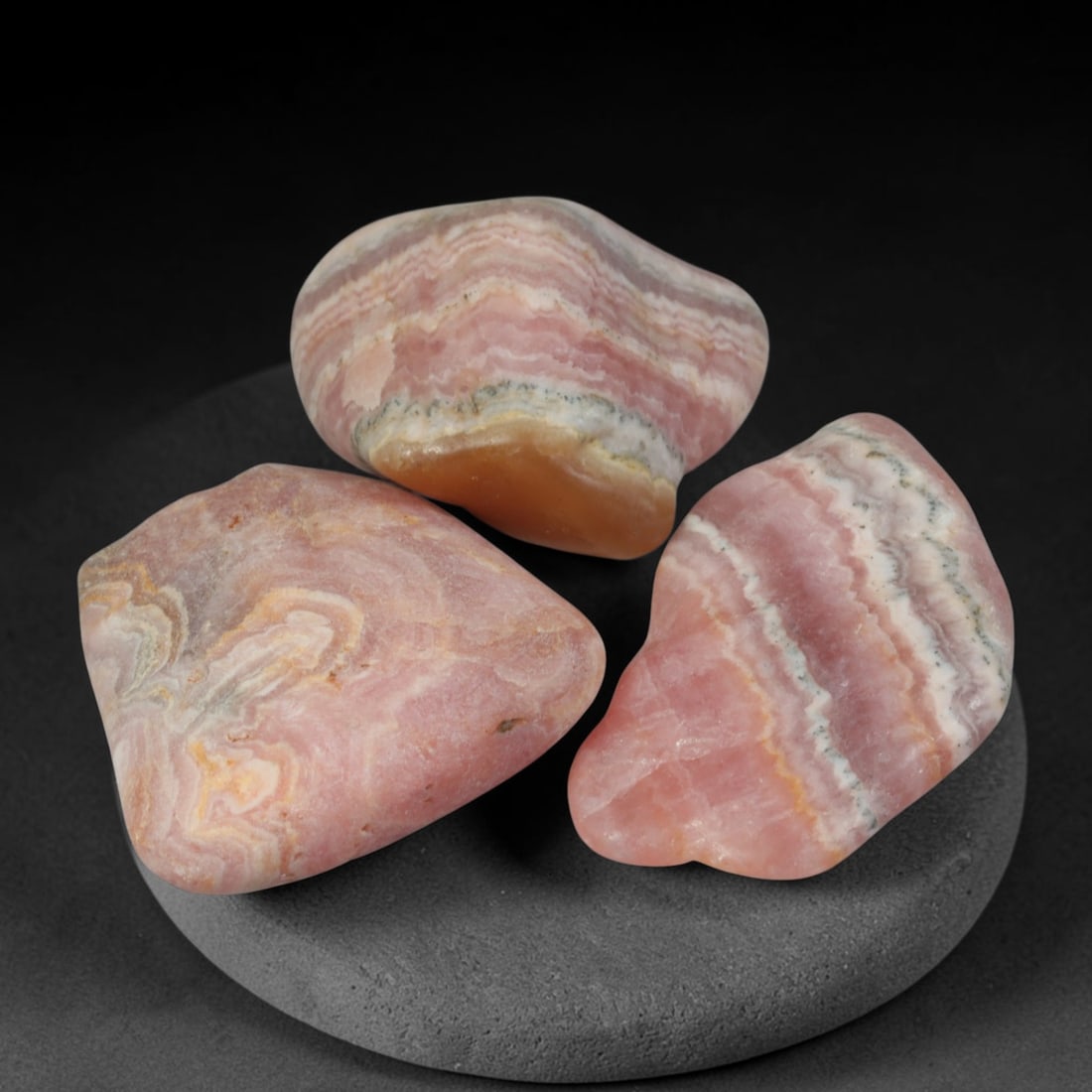 64ct 3pcs Natural Argentine Rhodochrosite Banded Tumbled Rough Set, 8YR: This listing features three individual tumbled rhodochrosite rough pieces sourced from Argentina Capillitas deposits, each showcasing distinct layered banding of soft rose pink, cream white and pale t
