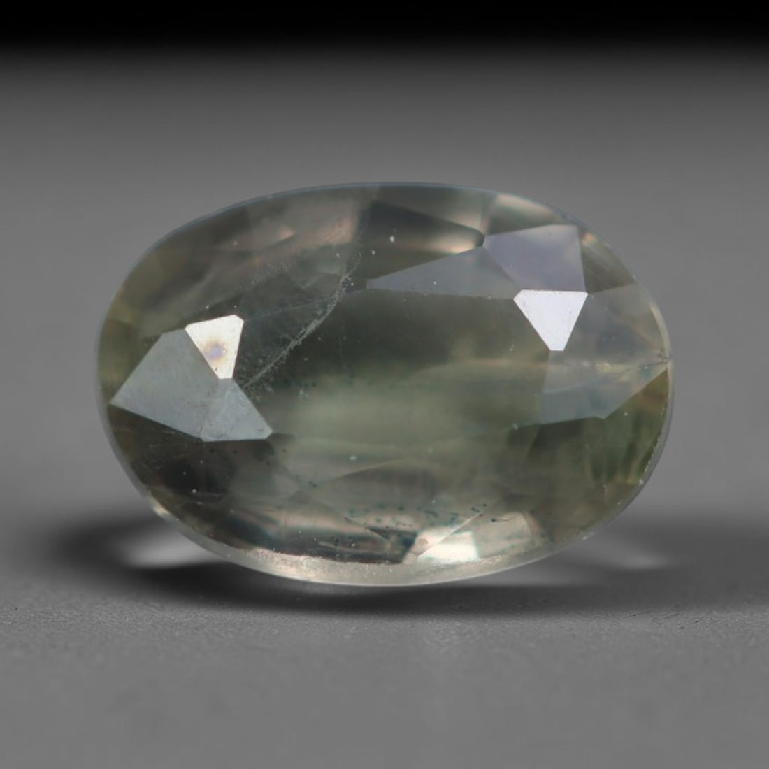 0.49 Carats Natural Pale Sage Green Sapphire Loose Faceted Gemstone, 13XM: Natural muted pale sage green corundum sapphire finely faceted loose gemstone, brilliant cut construction delivers soft light dispersion and subtle translucent grey-green body tone. The crystal matrix
