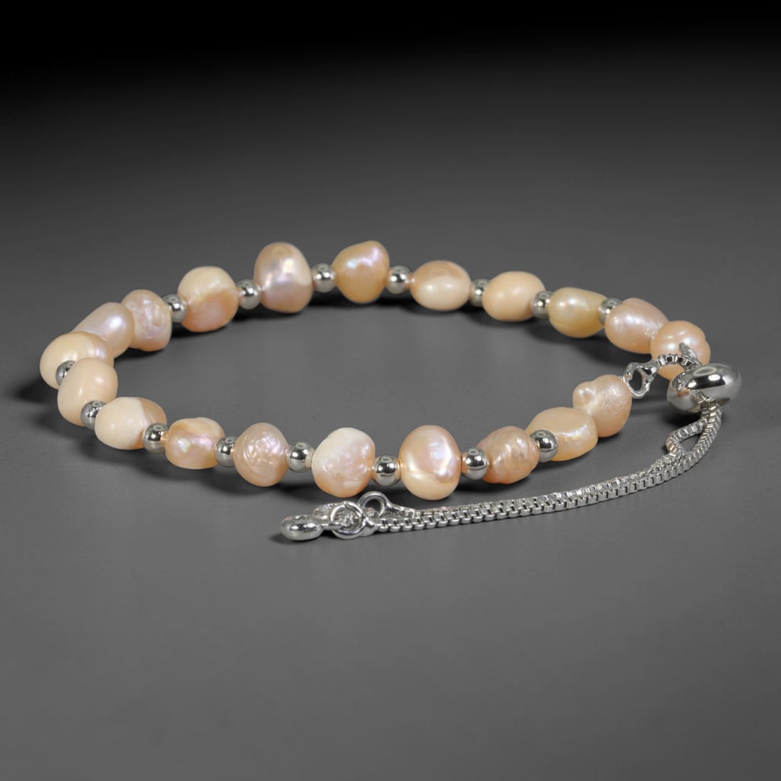 Natural Freshwater Pearl Bracelet - Baroque Peach Pearl Strand, 92YG: Composed of irregular baroque natural freshwater pearls with soft peach iridescent luster, each pearl exhibiting organic ununiform contours characteristic of unprocessed freshwater pearl growth. Indiv