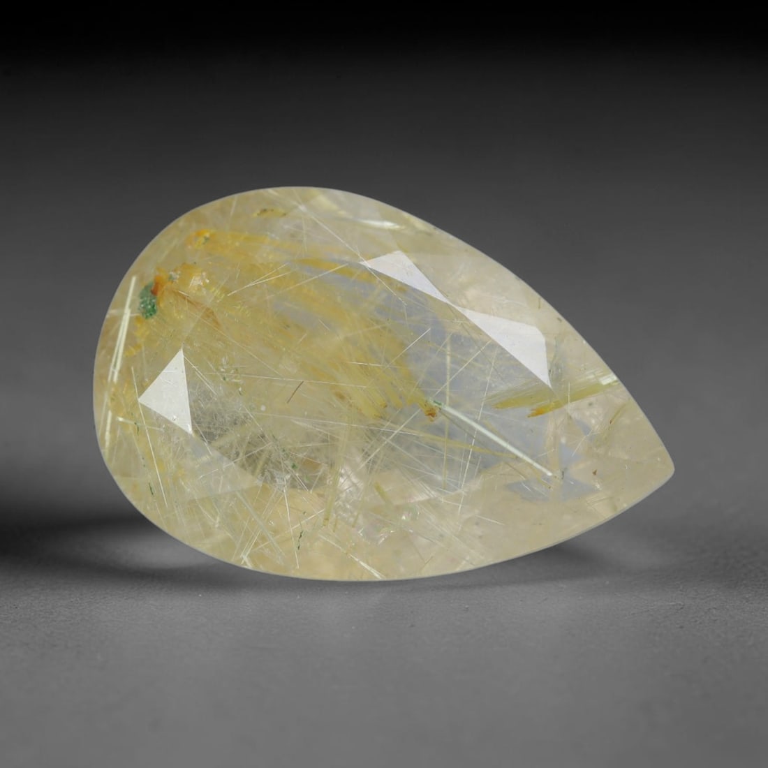 4.28 Carats Natural Golden Rutilated Quartz Pear Faceted Loose Gemstone, 17WS: This graceful pear teardrop faceted rutilated quartz features a pale translucent lemon crystal base filled with delicate crisscross golden rutile needle silk, accented by tiny scattered green mineral 