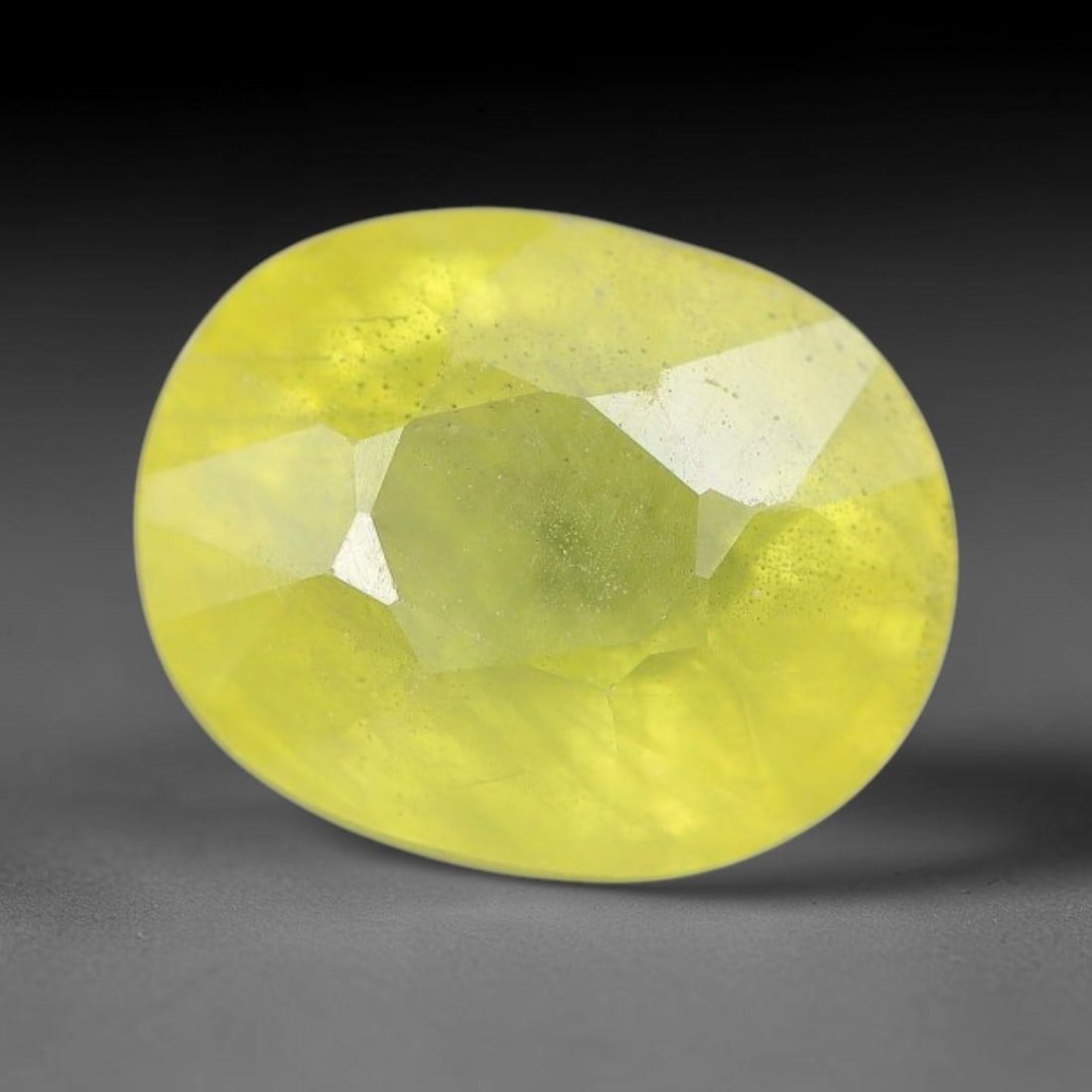 3.01 Carats Natural Yellow Sapphire Oval Faceted Loose Gemstone, 89XM: This natural yellow sapphire features a classic oval brilliant faceted cut, holding consistent warm golden-yellow color throughout the corundum crystal. Fine microscopic mineral specks and faint natur