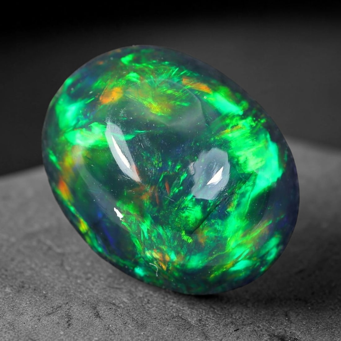 1.98ct Natural Ethiopian Welo Black Smoked Opal Cabochon Loose Gemstone, 93WP: This fully polished Ethiopian Welo opal features a dark smoked base with vivid, sweeping play-of-color shifting across its glossy dome surface, measured at 10.3x8.4x4.9mm. The black smoke treatment de