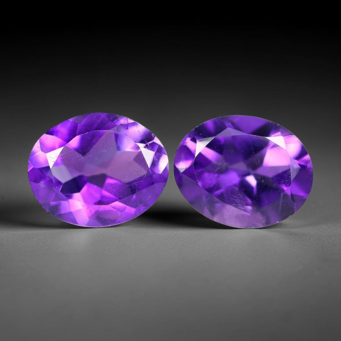4.69 Carats Natural Purple Amethyst Oval Faceted Pair Loose Gemstone, 27XX: Natural crystalline amethyst material processed with precision oval faceting for the matched gem pair, exhibiting rich saturated violet hue alongside subtle natural internal inclusions inherent to unt