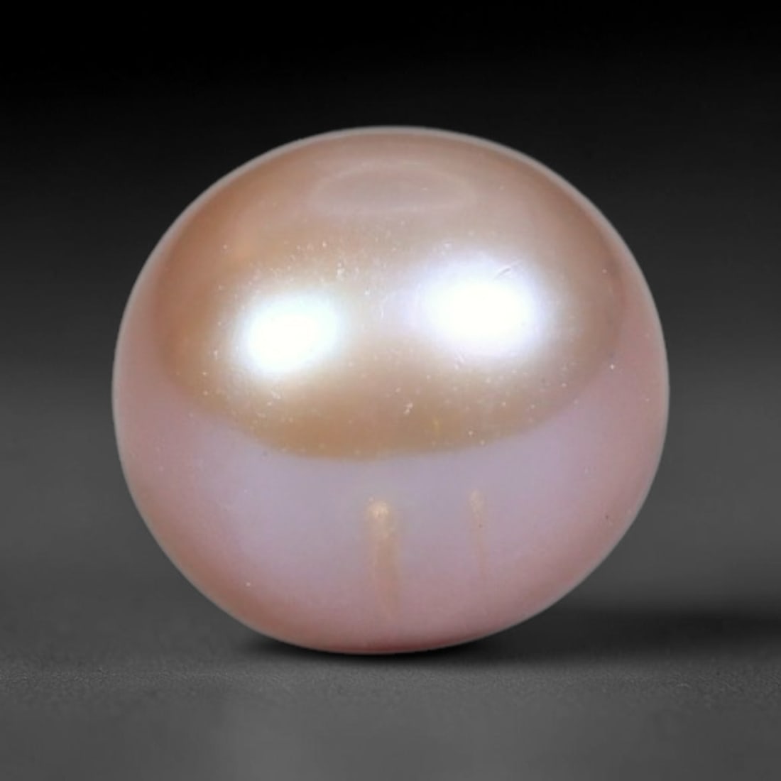 2.76ct Natural Round Freshwater Peach Pink Pearl Loose Gemstone 7.4mm, 48XZ: Flawless natural undrilled round freshwater pearl, showcasing a smooth symmetrical spherical form with soft gradient peach blush nacre transitioning from warm apricot crown to pale pink base. The pear