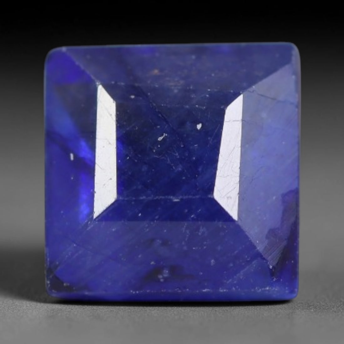 1.91 Carats Royal Blue Sapphire Square Emerald Cut Loose Gemstone, 37WS: This neat square emerald cut sapphire showcases deep, saturated royal blue color, enhanced by clean reflective step facets. Natural internal fine fissures and scattered tiny mineral specks can be obse