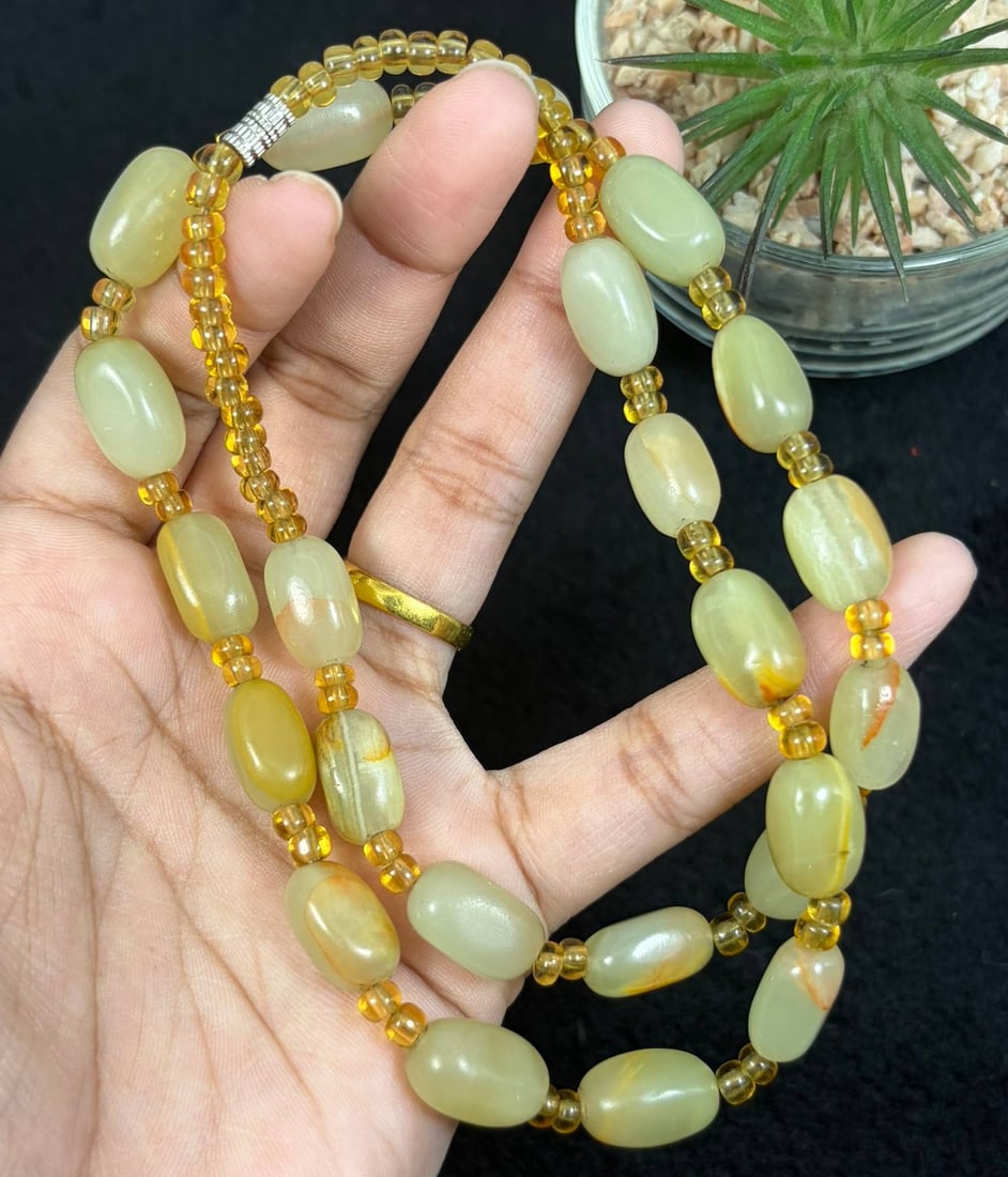 Natural Xinjiang Hetian Jade Pebble Beaded Necklace, 3YM: This elegant necklace features smooth, natural Hetian jade pebbles, strung with small translucent yellow spacer beads and finished with a silver-toned clasp. The jade pebbles display soft pale yellow 