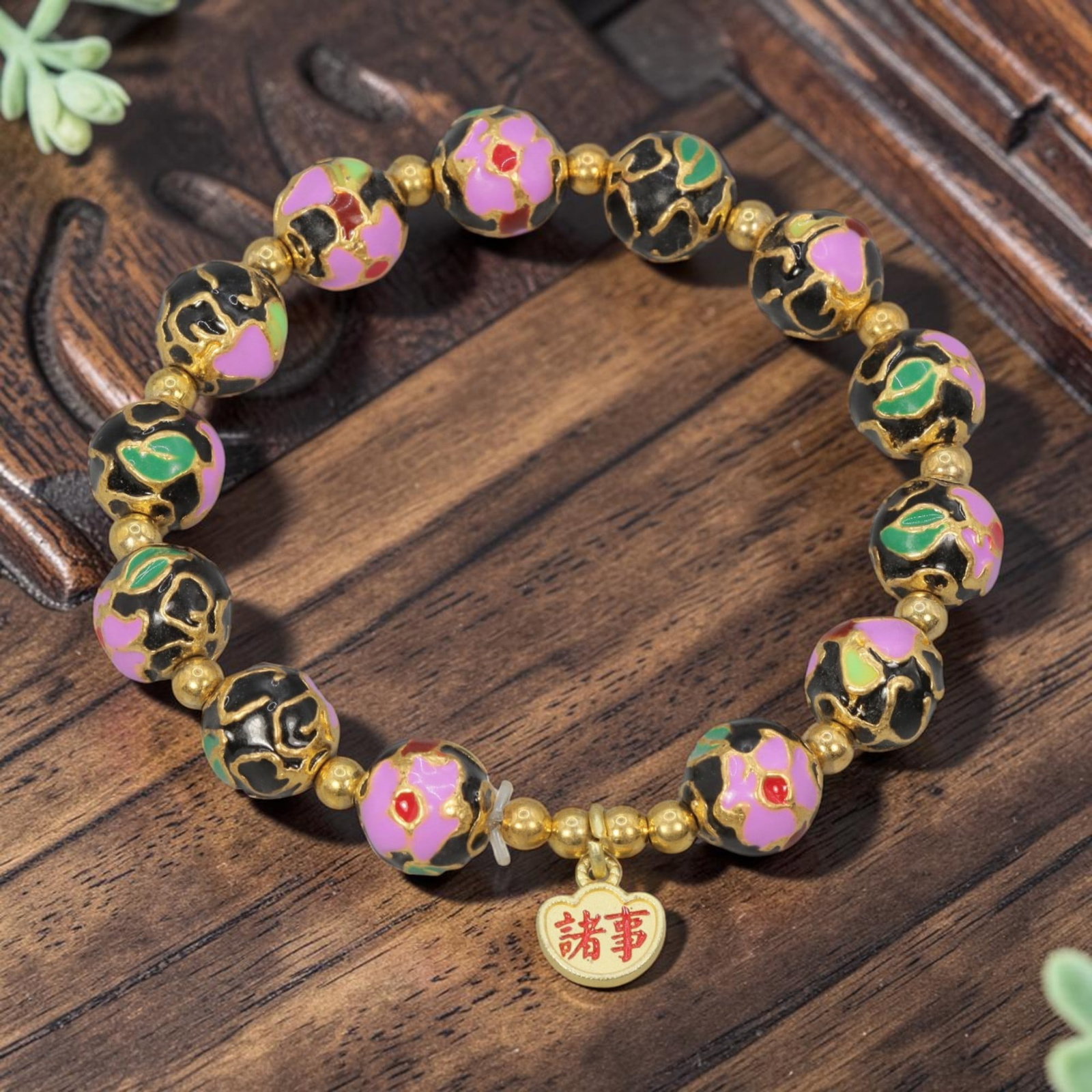 A Chinese Cloisonne Enamel Beaded Bracelet - Black Gold-Tone "All Things" Charm, 32YJ: This modern Chinese-style bracelet features 10.20mm round cloisonne enamel beads in a deep black hue, each detailed with raised gold-tone outlines framing pink floral motifs accented with green and re