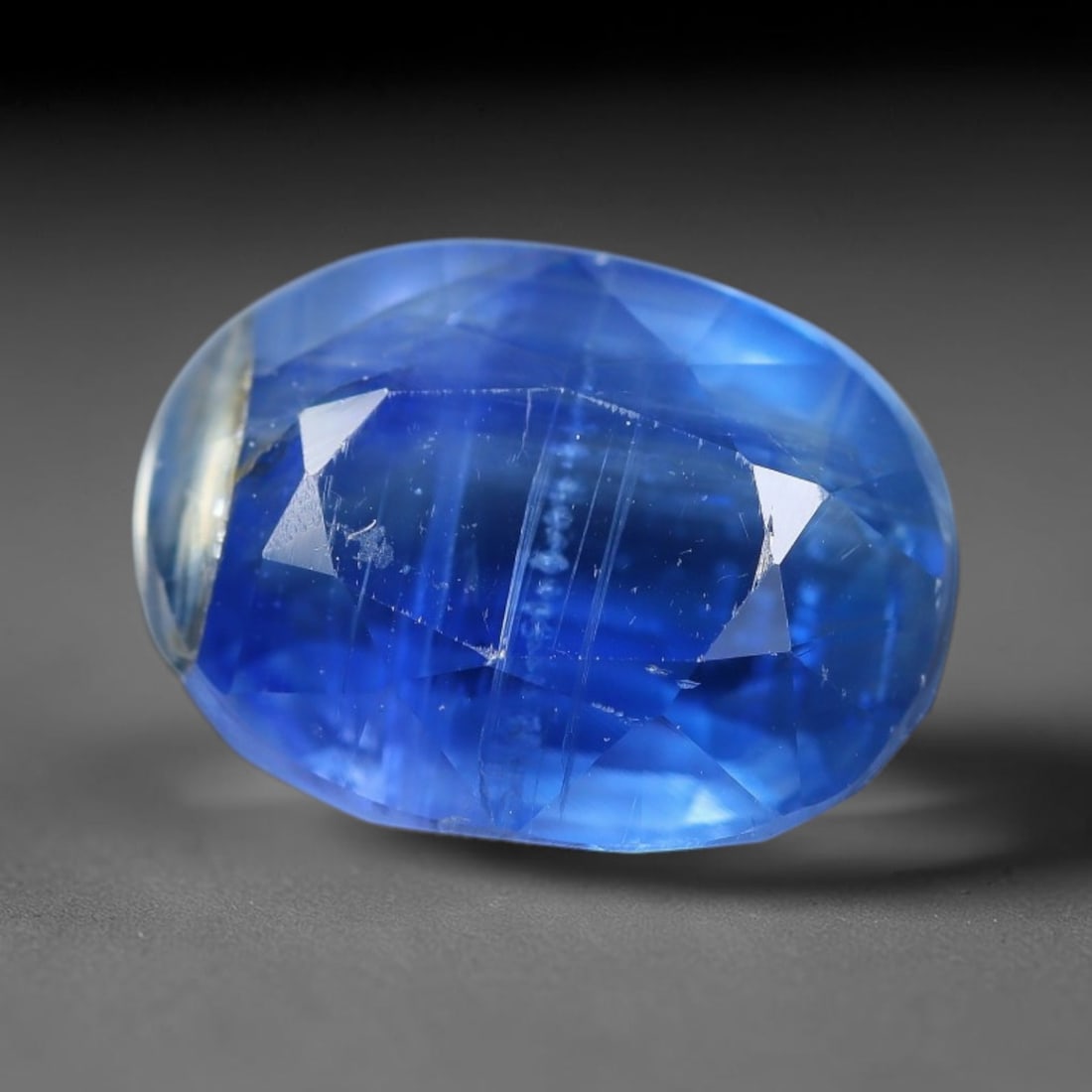 4.87 Carats Natural Intense Royal Blue Oval Faceted Kyanite Loose Gemstone, 29XV: Natural vivid saturated royal blue kyanite masterfully oval faceted loose gemstone, mixed brilliant facets deliver deep rich blue light refraction, distinguished by iconic parallel vertical fibrous si