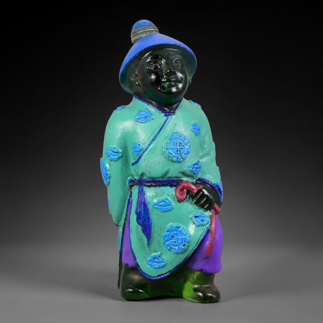 Vintage Chinese Liuli Glass Snuff Bottle - Standing Robed Attendant, 86YF: This snuff bottle is moulded from translucent green liuli glass, formed as a standing attendant with a traditional brimmed blue hat. The turquoise robe is decorated with raised blue floral roundels, a