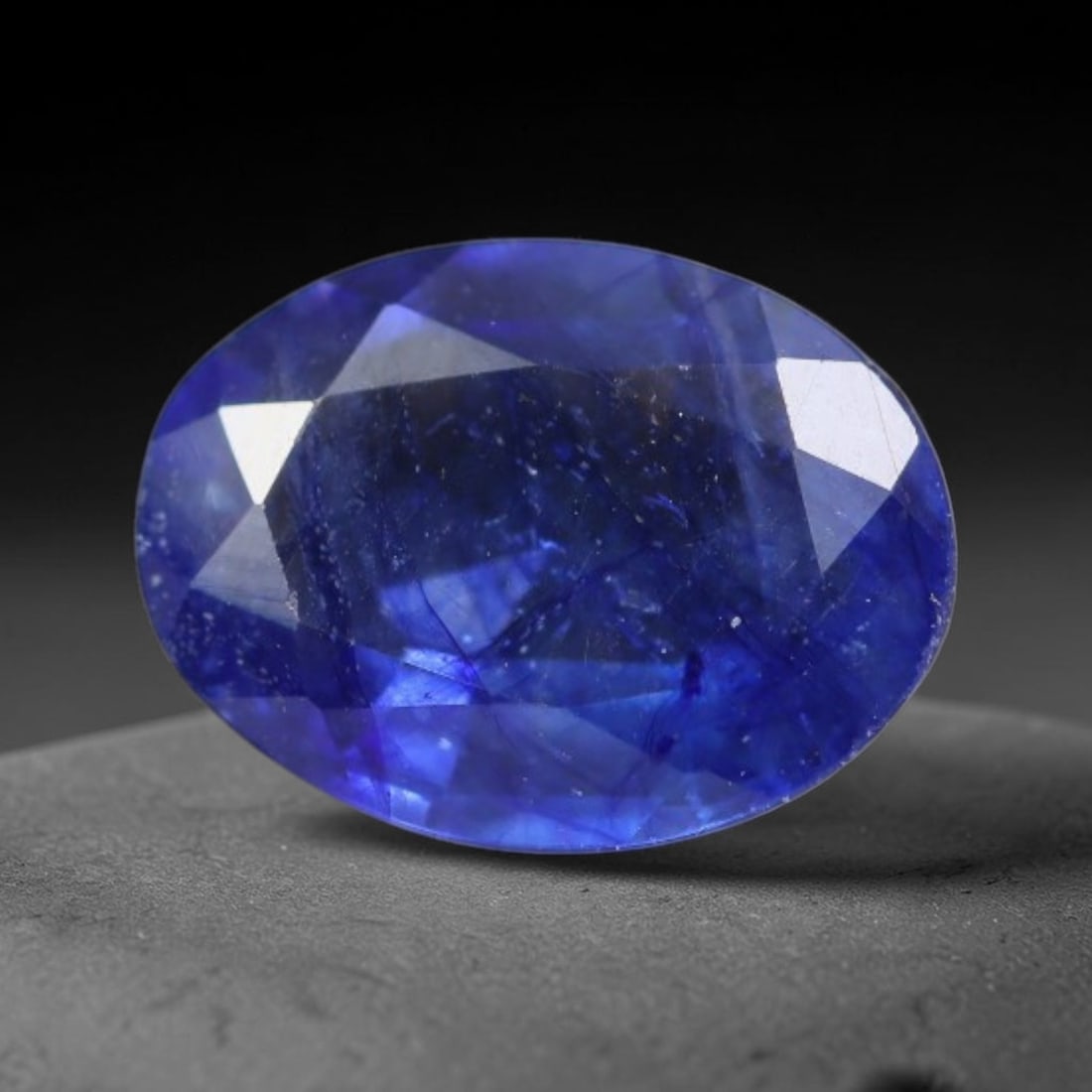1.41 Carats Royal Blue Sapphire Oval Faceted Loose Gemstone, 40WS: This classic oval faceted sapphire displays rich saturated royal blue color glowing through crisp polished multi-facet cuts, featuring natural fine internal fissures and tiny scattered mineral micro s