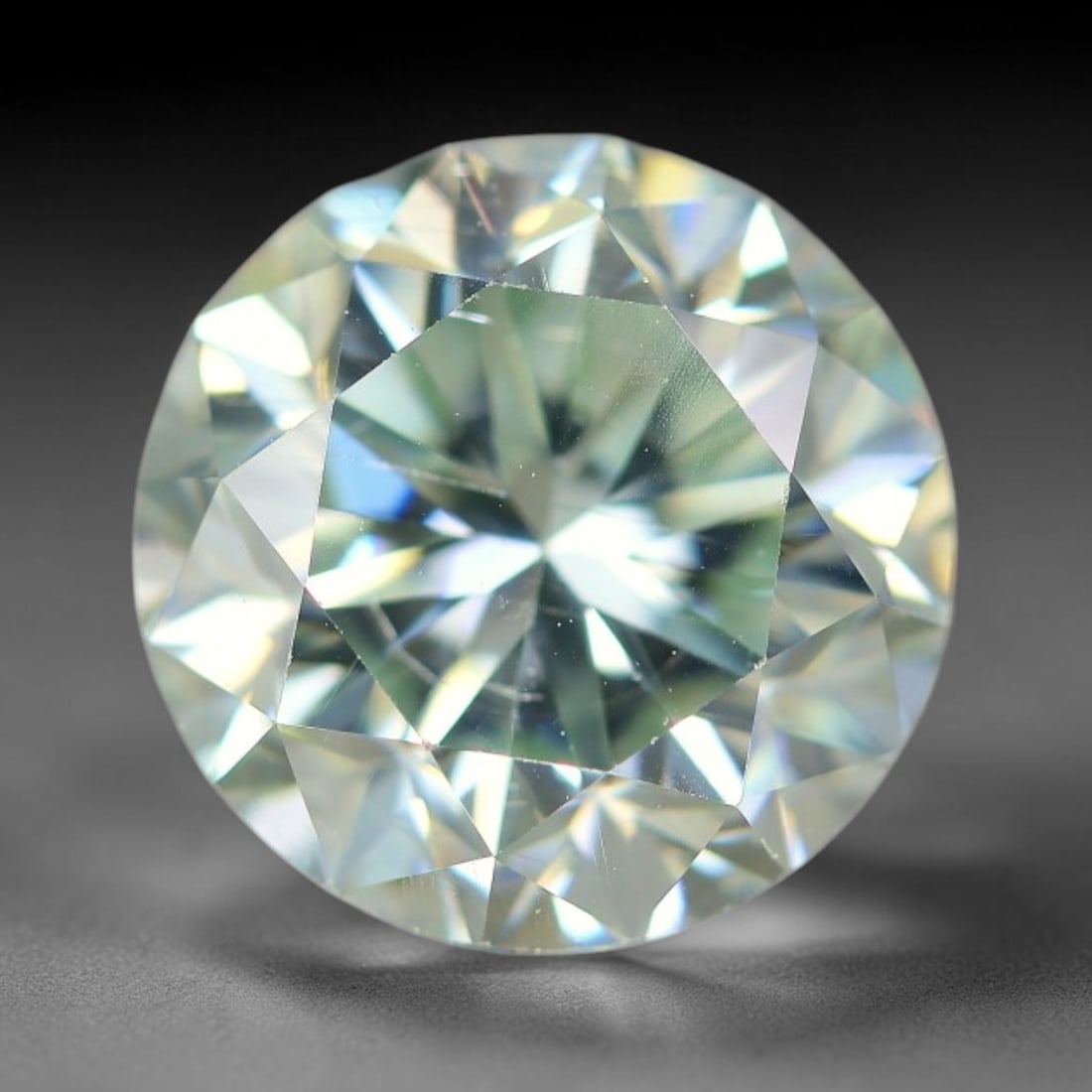 3.77 Carats Clear Moissanite Loose Gemstone, 81WP: This moissanite features dimensional measurements of 10x6.4mm, a lab-created silicon carbide gem material celebrated for an impressive refractive index that creates intense light dispersion and dynami