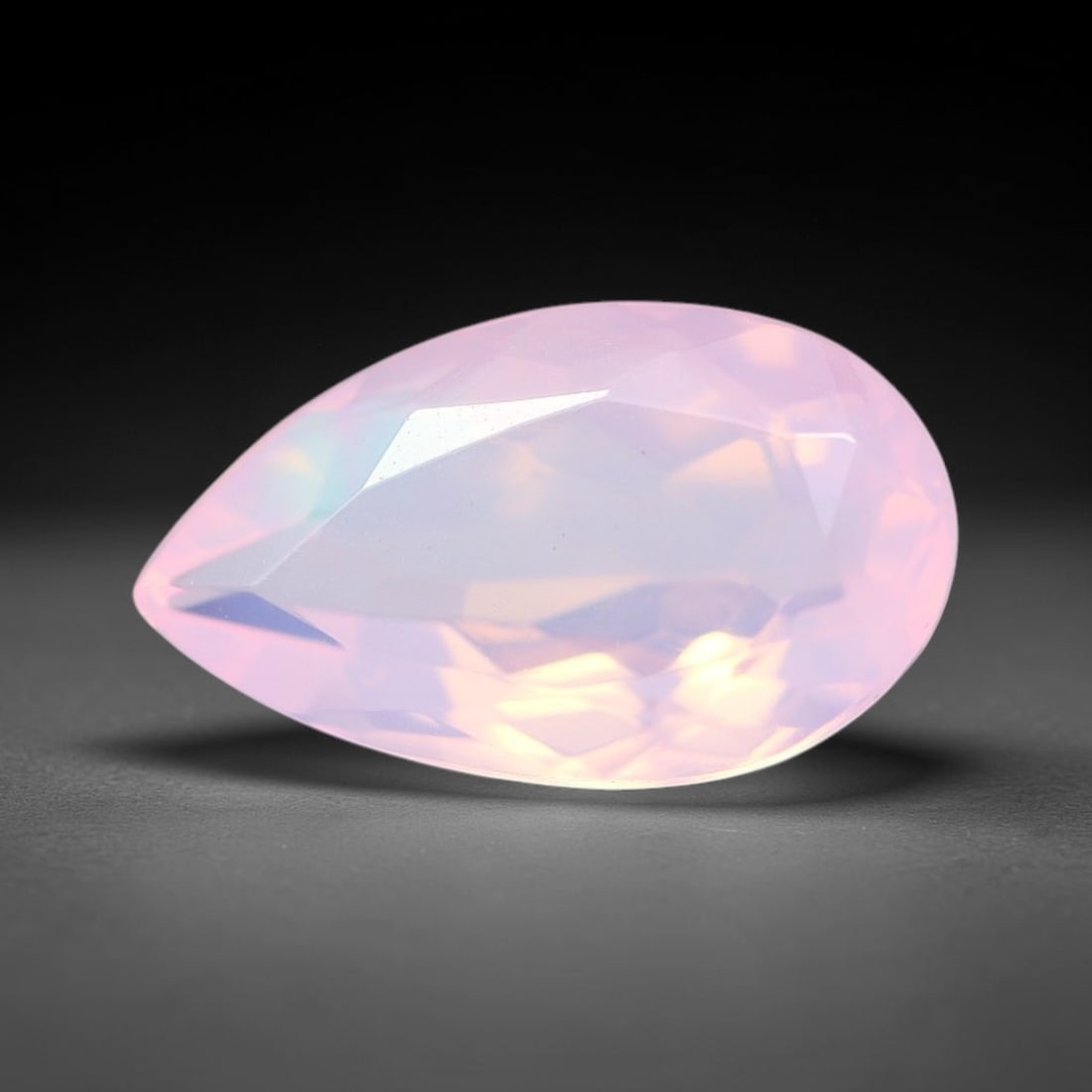 2.34 Carats Natural Ethiopian Welo Pink Fire Opal Pear Faceted Loose Gemstone, 78XX: This opal is sourced from the Welo mining region of Ethiopia and crafted into faceted form via professional lapidary cutting with smooth polished facets across the exterior surface. Subtle natural int