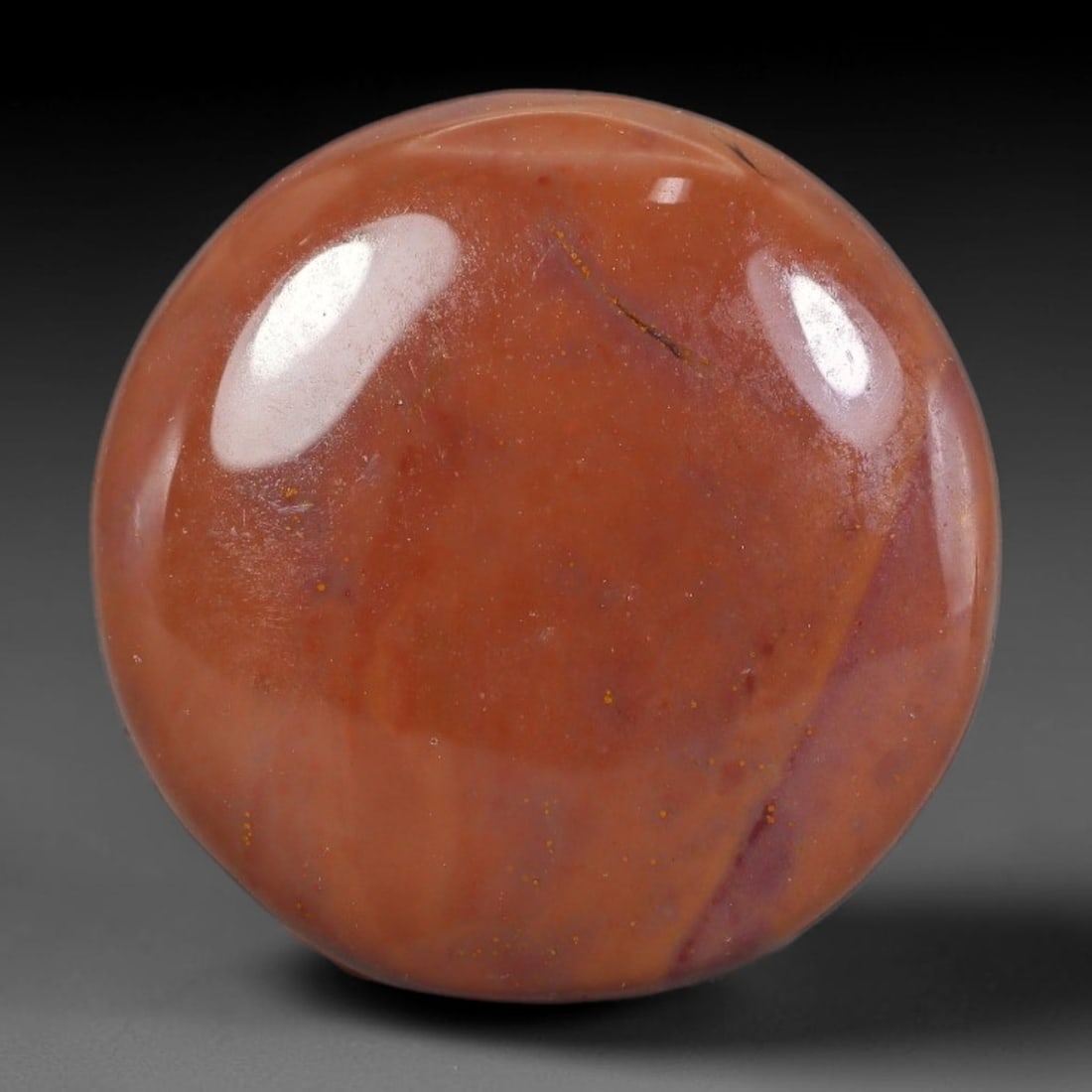31.41 Carats Natural Round Polished Jasper Cabochon Gemstone, 26XZ: This sleek domed round cabochon measures 25.0mm in diameter with a thickness of 6.2mm, weighing a total of 31.41 carats. It features a smooth, uniform warm terracotta and soft muted rose base tone, su