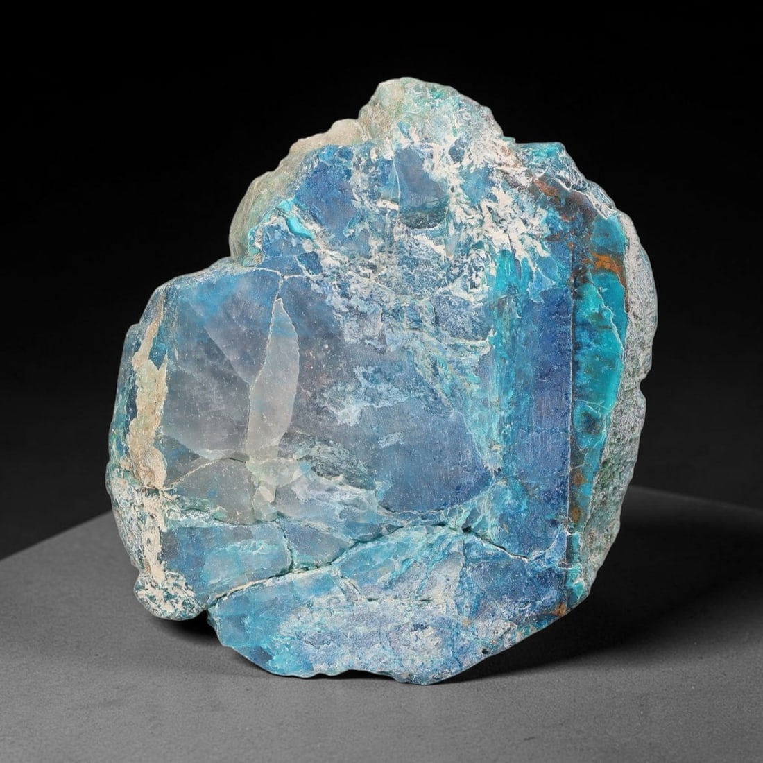 86ct Natural Peruvian Chrysocolla Polished Slab Rough, 46WV: This partial-polished chrysocolla slab features blended mineral matrix with smooth refined face and unaltered natural rugged edge across its 36x31x10mm elongated form, translucent mineral layers hold 