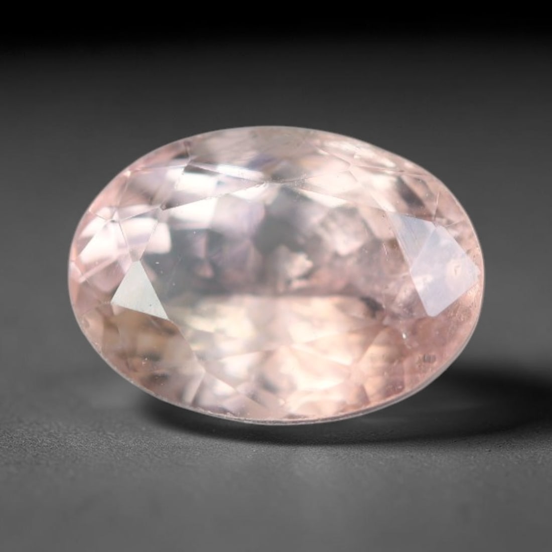 1.12 Carats Natural Pale Peach Pink Tourmaline Oval Faceted Loose Gemstone, 51WS: This refined oval faceted tourmaline carries a soft pale peach pink hue glowing through crisp polished facets, with faint tiny natural mineral specks scattered evenly inside its transparent crystal bo