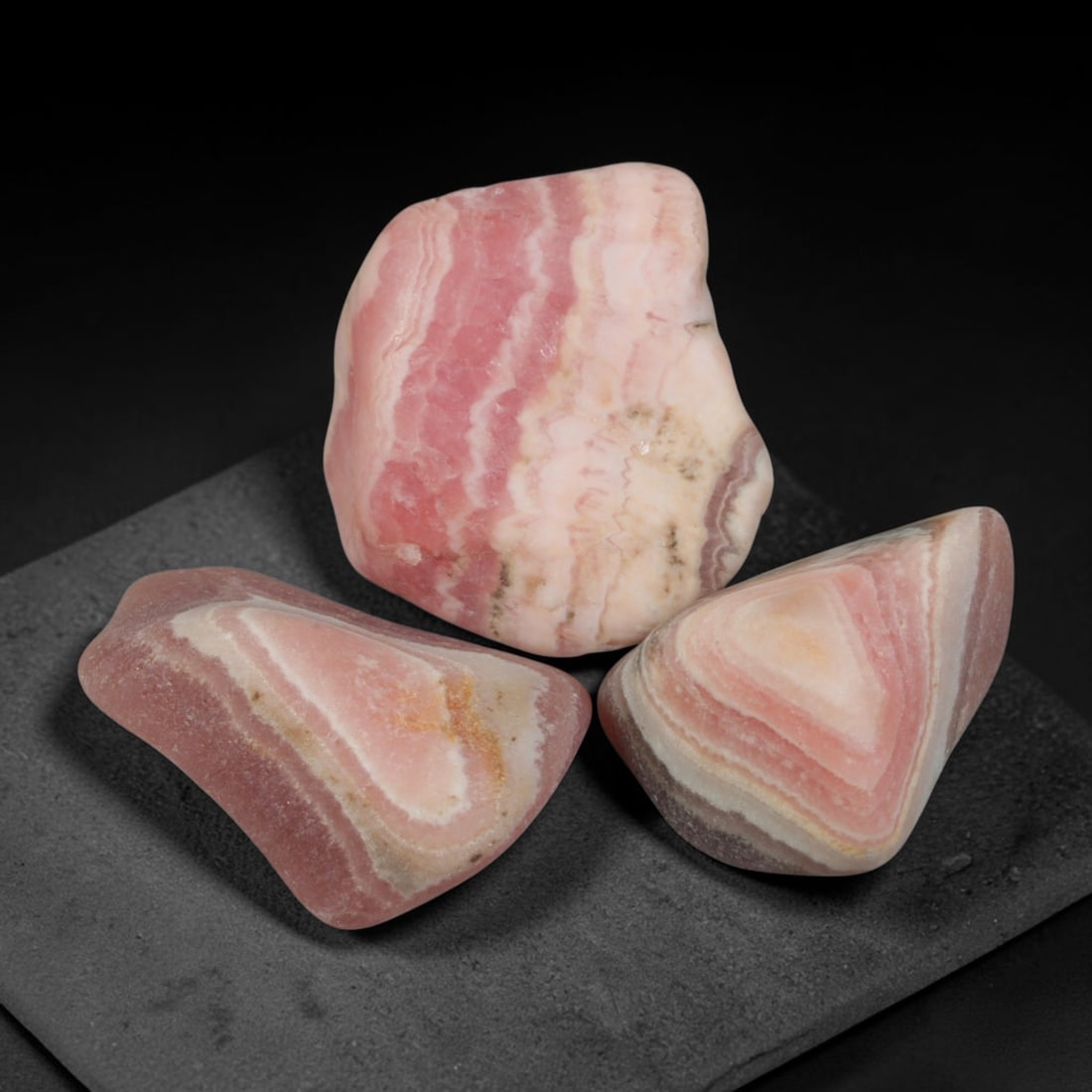 60ct 3pcs Natural Argentine Rhodochrosite Banded Tumbled Rough Set, 6YR: This listing features three individual tumbled rhodochrosite rough pieces sourced from Argentina Capillitas deposits, each showcasing distinct layered banding of soft rose pink, cream white and pale t