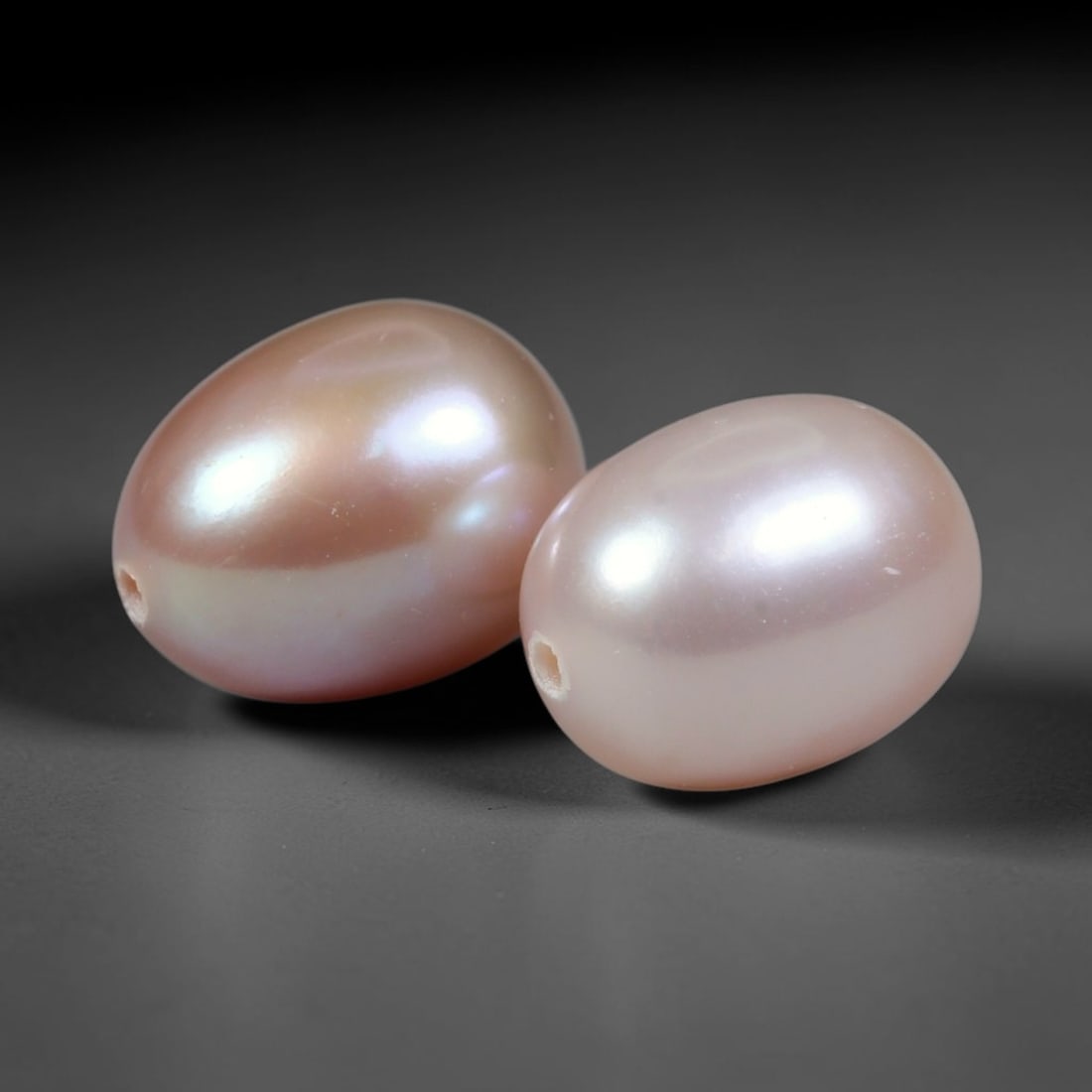 7.00ct Natural Soft Mauve Pink Orient Freshwater Egg Shape Pearl Pair, 67XZ: Matching pair of natural freshwater egg/oval pearls, uniform dimensions 9.4x7.3mm with neat fully drilled through holes ready for immediate jewelry assembly. Each pearl boasts a smooth satiny nacre su