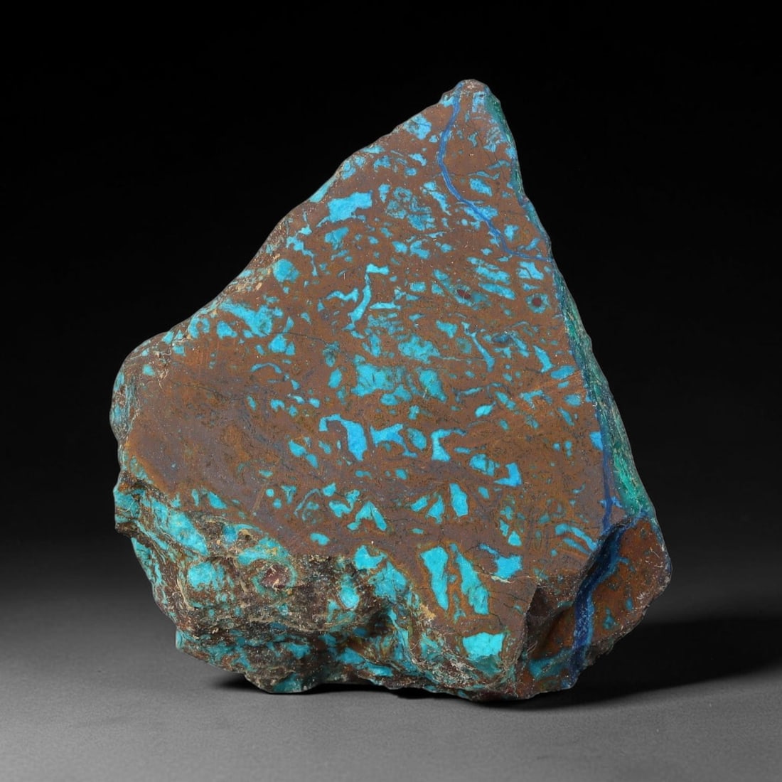 98ct Natural Peruvian Chrysocolla Polished Slab Rough, 56WV: This partial-polished chrysocolla slab features blended mineral matrix with smooth refined face and unaltered natural rugged edge across its 37x33x9mm elongated form, translucent mineral layers hold s