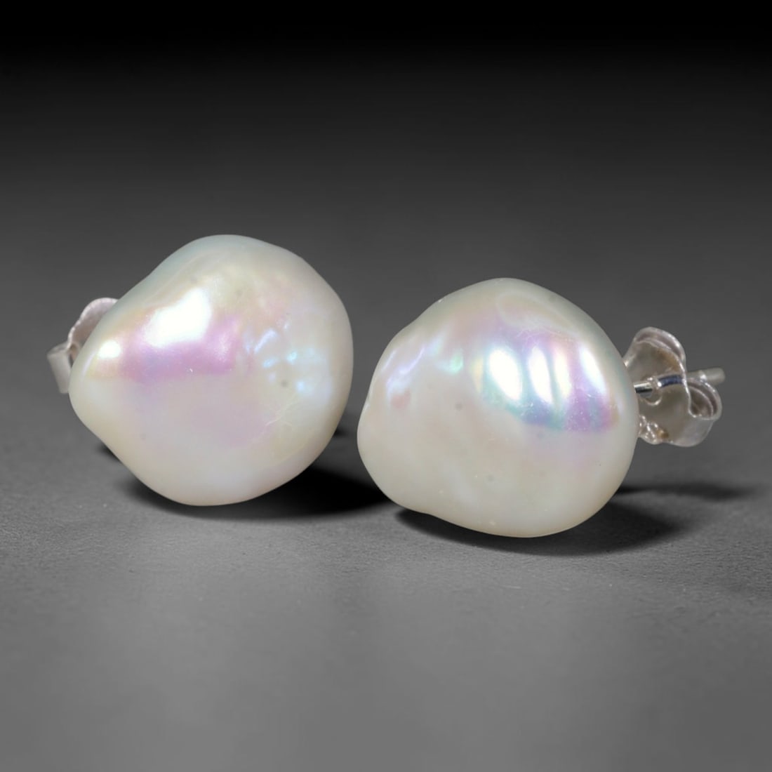 Natural Freeform Baroque Button Pearl Stud Earrings, 4WS: Matching classic stud earrings featuring organic rounded freeform button baroque freshwater pearls, each measuring 12.6x6.2mm. Thick luminous natural nacre forms a soft milky ivory base, adorned with 