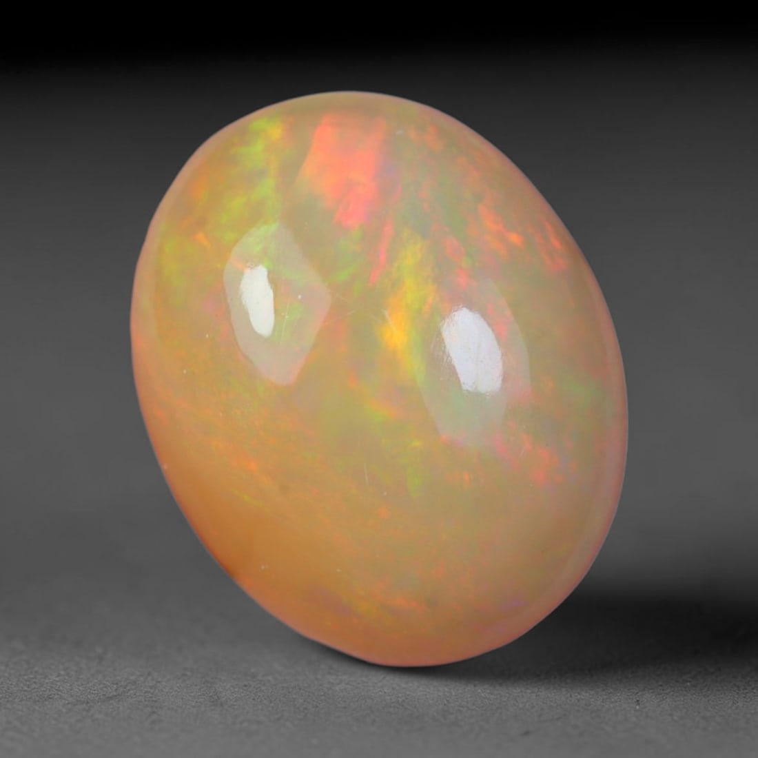 2.84 Carats Natural Ethiopian Welo Opal Oval Cabochon Loose Gemstone, 39XV: Natural Ethiopian Welo opal polished oval cabochon loose gemstone, luminous translucent milky white base stone with vivid multi-hued play-of-color featuring bright emerald green, lime yellow, soft blu