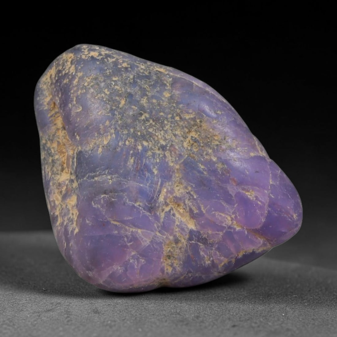 29ct Natural Unheated Sri Lankan Purplish Blue Sapphire Rough, 45YQ: This natural corundum rough is an unheated purplish blue sapphire sourced from Sri Lankan alluvial gem deposits, featuring an irregular natural native form with residual pale yellow-brown mineral matr