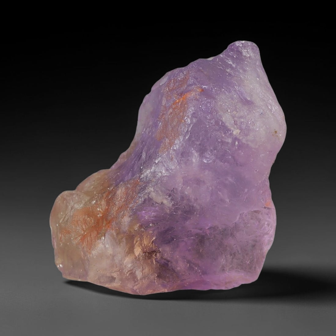 62.78 Carats Natural Bi-Color Ametrine Raw Rough Crystal Chunk, 77YR: This genuine natural ametrine rough showcases a seamless blend of soft lavender amethyst and pale golden citrine hues formed within a single quartz crystal. Delicate rusty orange mineral inclusions an