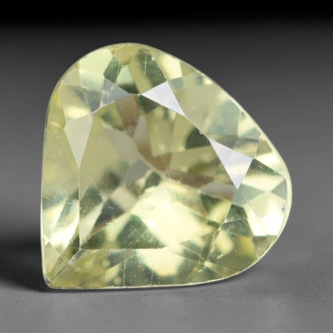 1.40 Carats Natural Pale Yellow Apatite Faceted Loose Gemstone, 52XY: This apatite specimen is sourced from natural geological deposits and shaped with professional faceting and high-gloss polishing work across the outer facet surfaces. Minute internal mineral inclusion