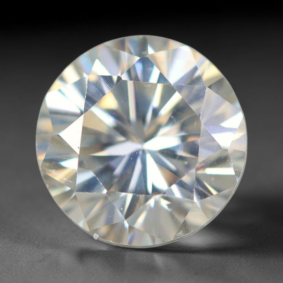 3.39 Carats Clear Moissanite Loose Gemstone, 76WP: This moissanite features dimensional measurements of 9.4x6.4mm, a lab-created silicon carbide gem material celebrated for an impressive refractive index that creates intense light dispersion and dynam