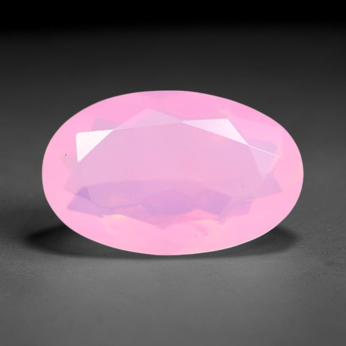 1.51 Carats Natural Ethiopian Welo Pink Fire Opal Oval Faceted Loose Gemstone, 74XX: This opal is sourced from the Welo mining region of Ethiopia and crafted into faceted form via professional lapidary cutting with smooth polished facets across the exterior surface. Subtle natural int