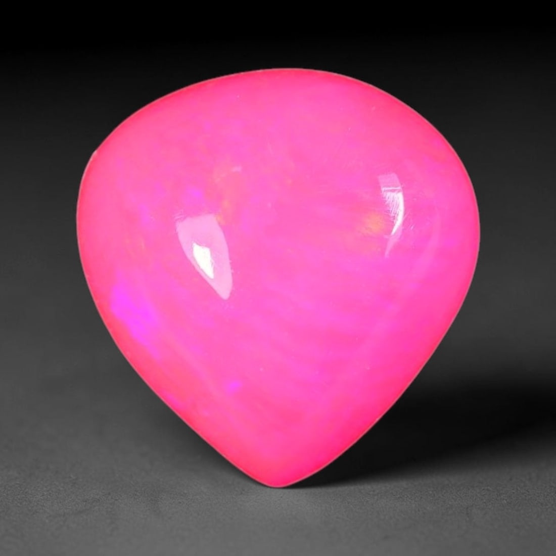 2.63ct Natural Ethiopian Welo Pink Fire Opal Pear Cabochon Loose Gemstone, 66XX: This opal originates from Ethiopian Welo opal bearing strata and is crafted into a sleek pear cabochon with smooth, high-gloss polishing through professional lapidary work. Soft pink base tone paired 