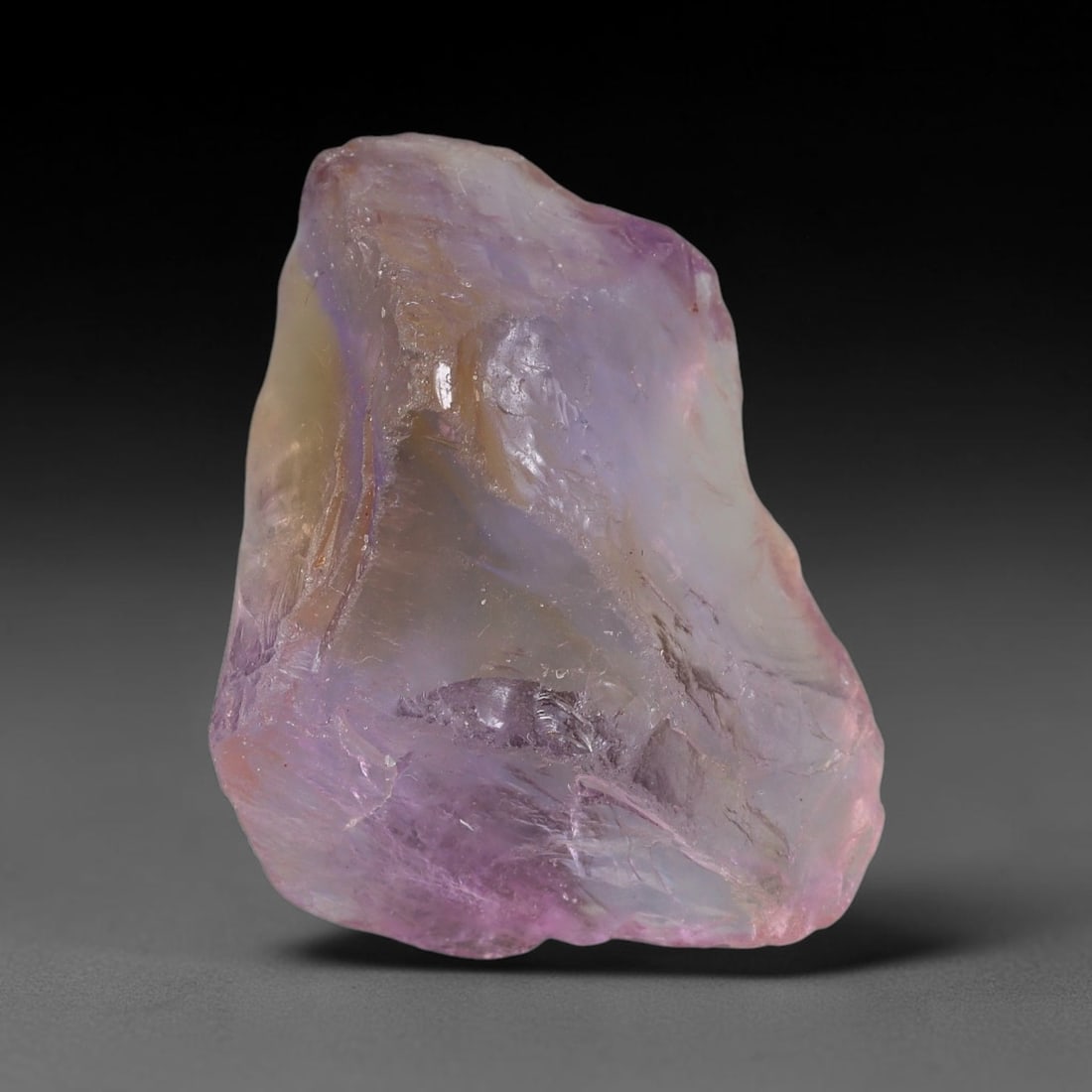 66.46 Carats Natural Bi-Color Ametrine Raw Rough Crystal Chunk, 76YR: This genuine natural ametrine rough showcases a seamless blend of soft lavender amethyst and pale golden citrine hues formed within a single quartz crystal. Delicate rusty orange mineral inclusions an