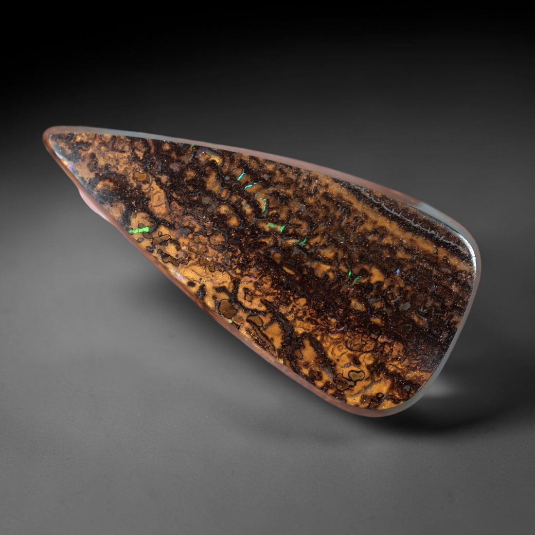 11.83 Carats Boulder Opal Cabochon - Intricate Matrix & Green Play-of-Color Specimen, 35XM: This 11.83ct boulder opal cabochon, measuring 26x12mm, is a striking example of Australia's iconic gemstone, showcasing the unique beauty of nature's artistry. The elongated, freeform cabochon is poli